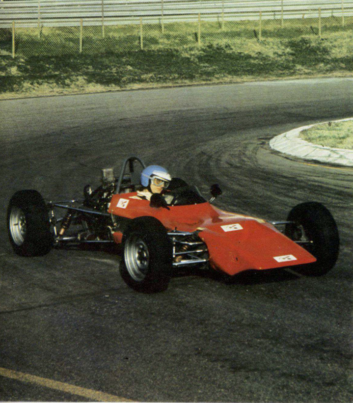 A person driving a race carDescription automatically generated