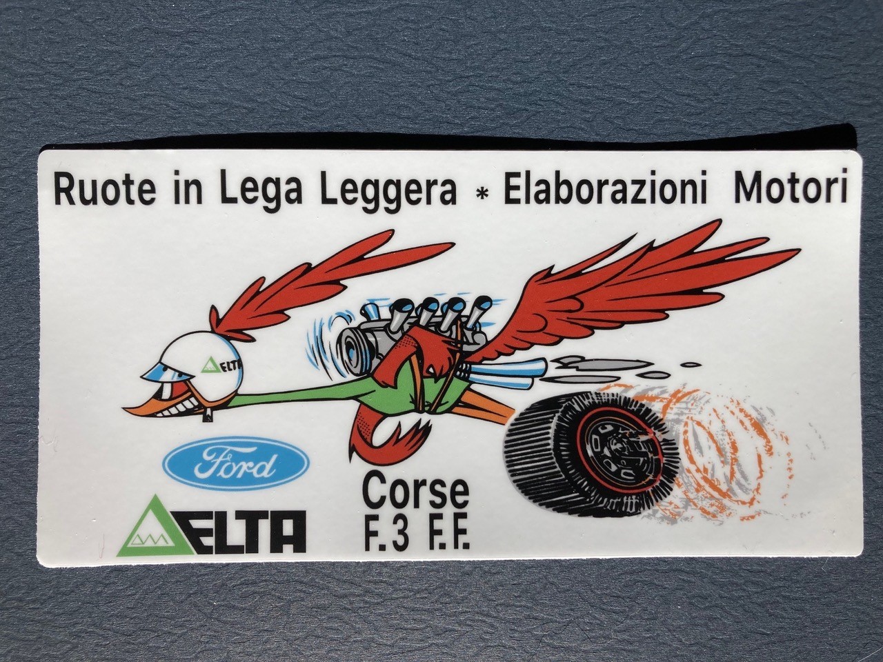 A sticker with a cartoon bird flying on itDescription automatically generated